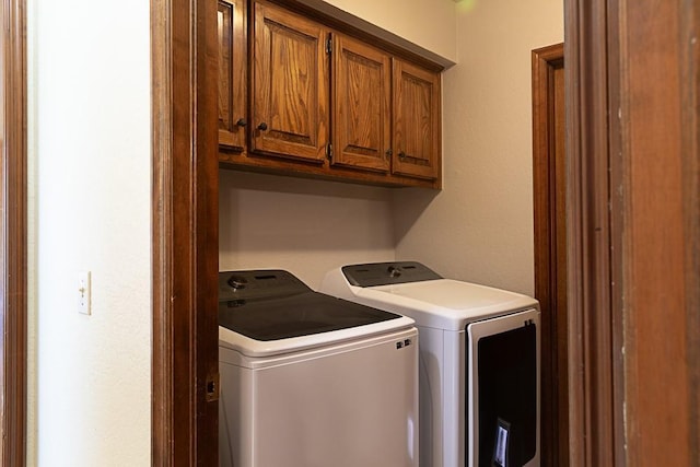 laundry area with cabinet space and washer and dryer