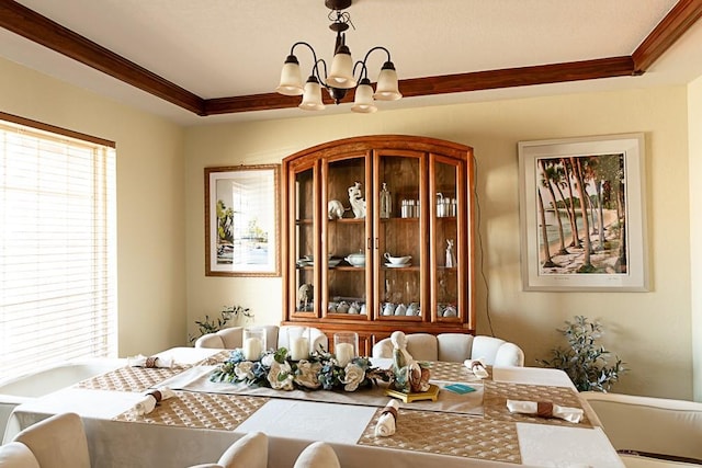 dining room with crown molding and an inviting chandelier