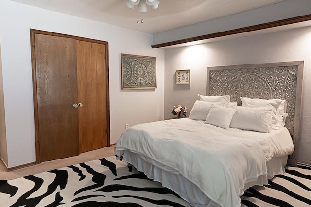 carpeted bedroom with a closet and a ceiling fan