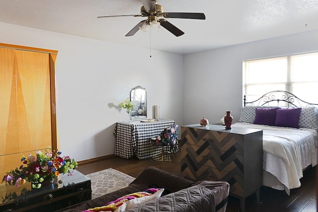 bedroom with ceiling fan, baseboards, and wood finished floors