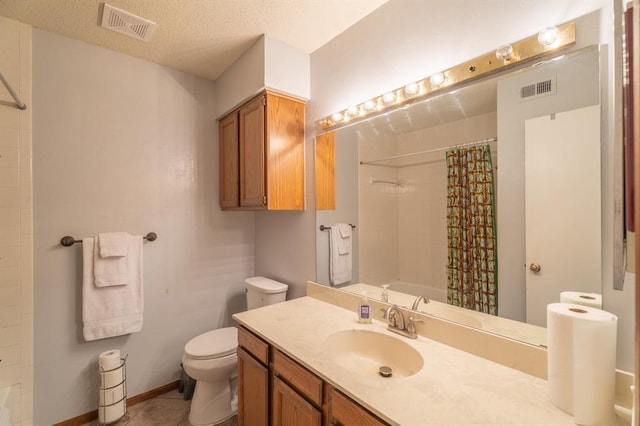 bathroom with vanity, toilet, visible vents, and a textured ceiling