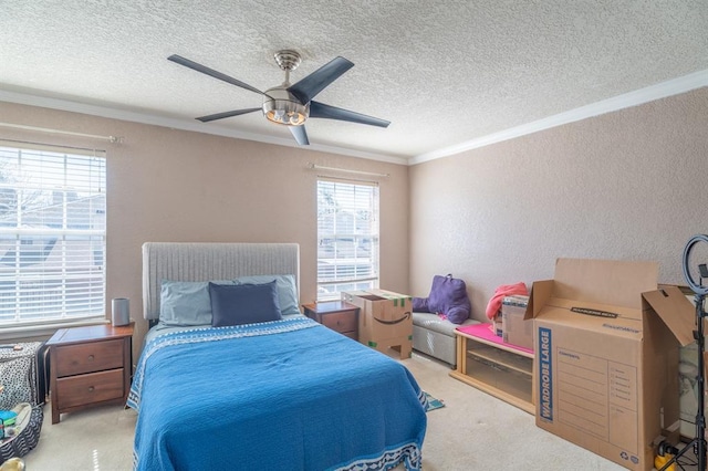 carpeted bedroom featuring ceiling fan, a textured ceiling, a textured wall, and ornamental molding