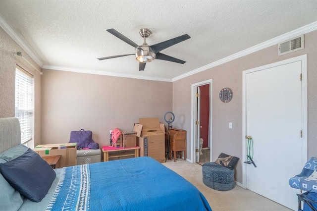 bedroom with visible vents, a textured ceiling, carpet, and ornamental molding