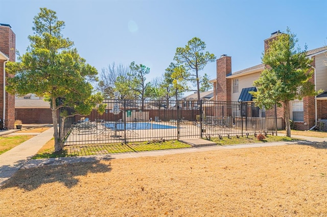 exterior space featuring a patio area, a fenced in pool, and fence