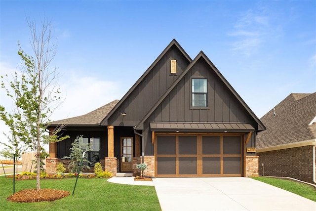 view of front of home featuring a standing seam roof, a front lawn, board and batten siding, and driveway