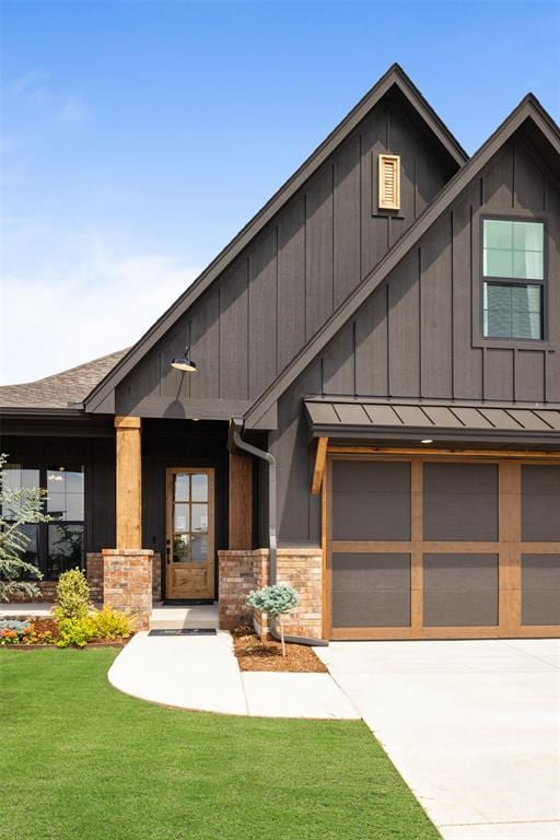 view of front of house featuring board and batten siding, a front lawn, concrete driveway, an attached garage, and a standing seam roof