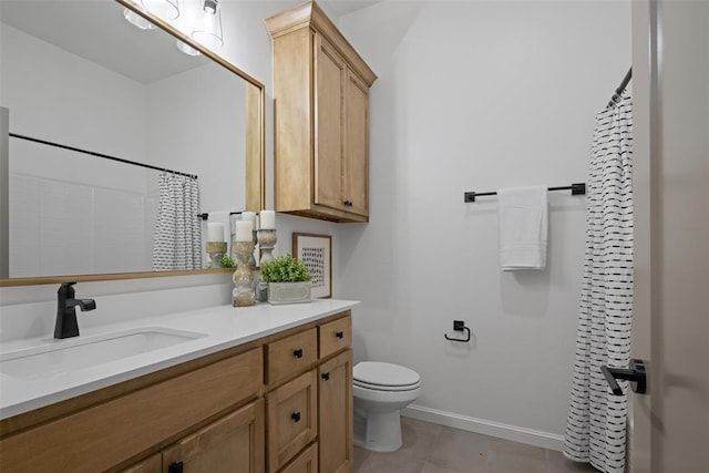 bathroom with vanity, baseboards, tile patterned flooring, curtained shower, and toilet