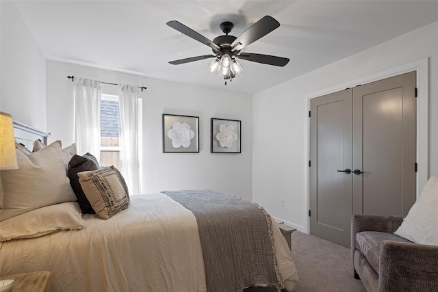 bedroom with baseboards, carpet floors, and a ceiling fan