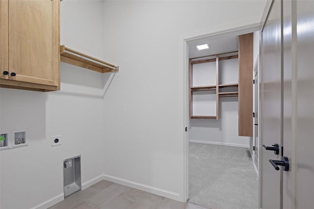 clothes washing area with electric dryer hookup, cabinet space, baseboards, light colored carpet, and hookup for a washing machine