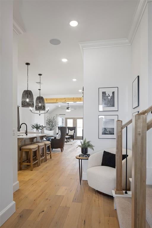 interior space featuring crown molding, baseboards, recessed lighting, light wood-style floors, and a ceiling fan