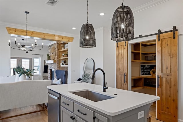 kitchen with visible vents, ornamental molding, a sink, stainless steel dishwasher, and a notable chandelier