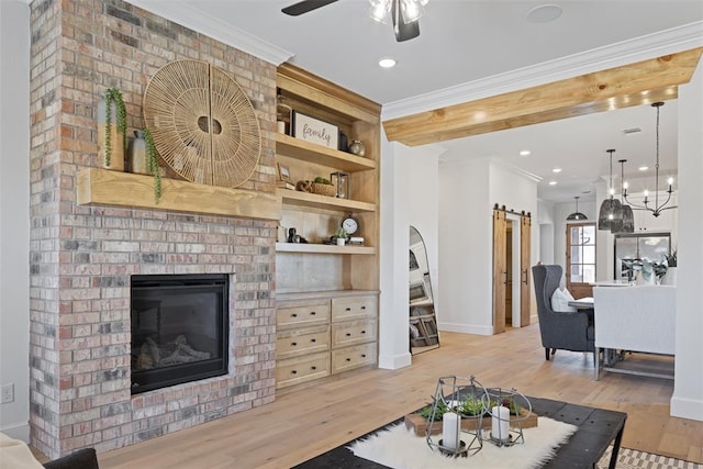 living area with a fireplace, wood finished floors, and crown molding