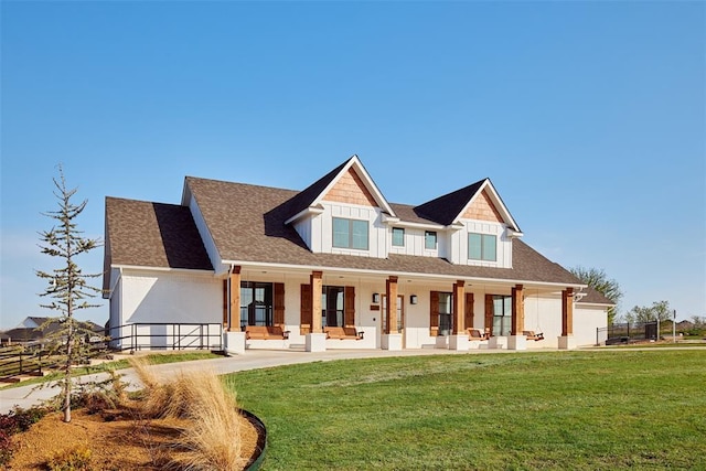 exterior space with fence, a front lawn, and roof with shingles