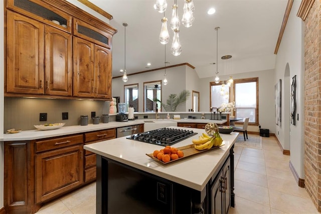 kitchen featuring a kitchen island, a peninsula, black gas stovetop, brown cabinetry, and stainless steel dishwasher