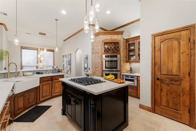 kitchen with glass insert cabinets, double oven, light countertops, gas stovetop, and a sink