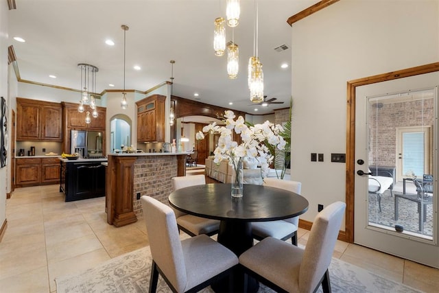 dining space featuring visible vents, recessed lighting, arched walkways, crown molding, and light tile patterned floors