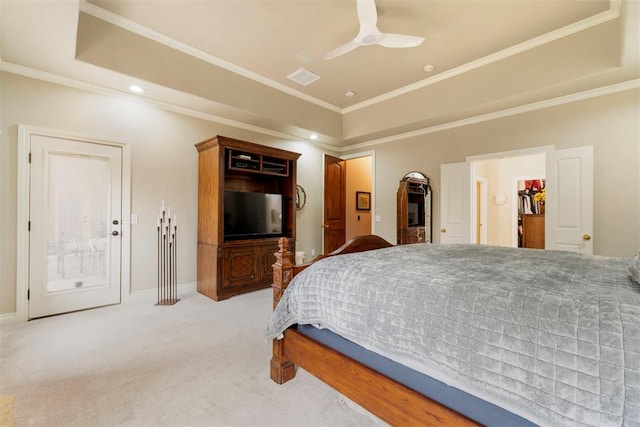 bedroom featuring ceiling fan, baseboards, a tray ceiling, ornamental molding, and light carpet