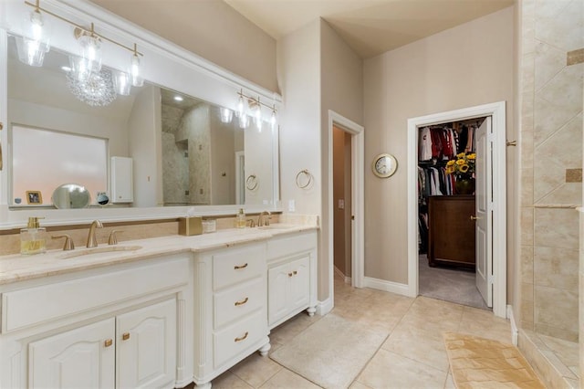 full bath featuring a sink, double vanity, a shower stall, and tile patterned flooring