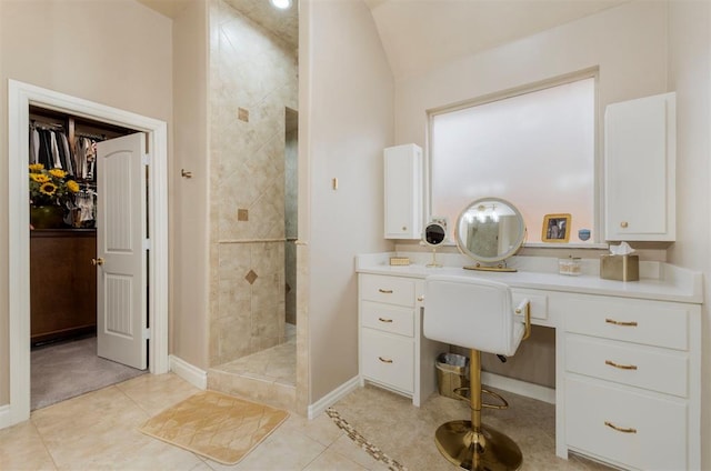 full bathroom with baseboards, vaulted ceiling, a walk in shower, a walk in closet, and tile patterned floors