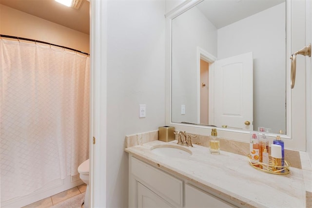 bathroom with vanity, toilet, and tile patterned flooring