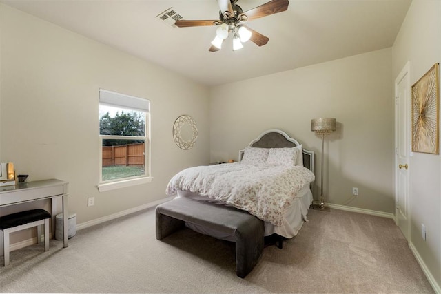 bedroom with ceiling fan, baseboards, visible vents, and light carpet