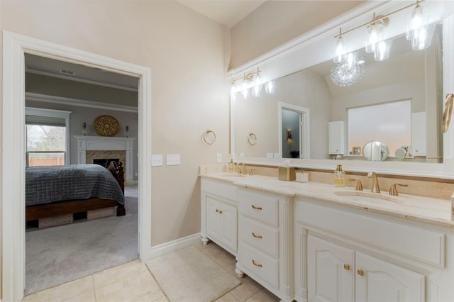 full bathroom with a fireplace, tile patterned floors, double vanity, and a sink