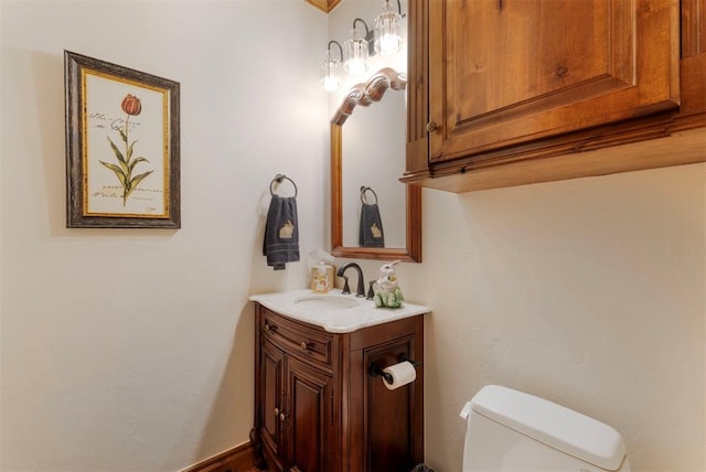 half bath featuring toilet and vanity