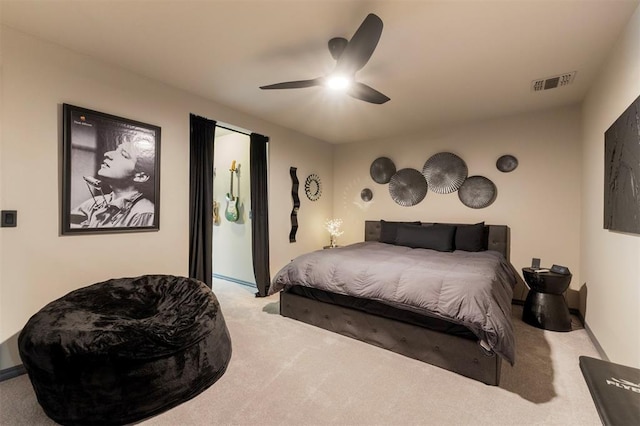 carpeted bedroom featuring visible vents and a ceiling fan