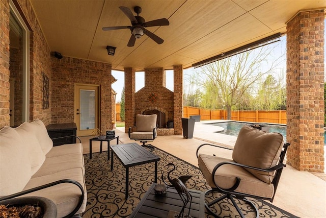 view of patio with a ceiling fan, an outdoor living space with a fireplace, a fenced backyard, and a fenced in pool