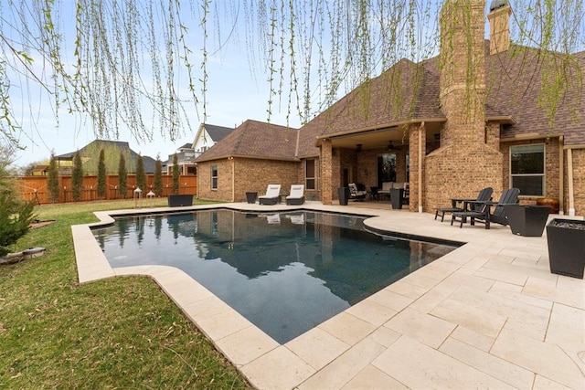 view of swimming pool with a fenced in pool, fence, a lawn, outdoor lounge area, and a patio area