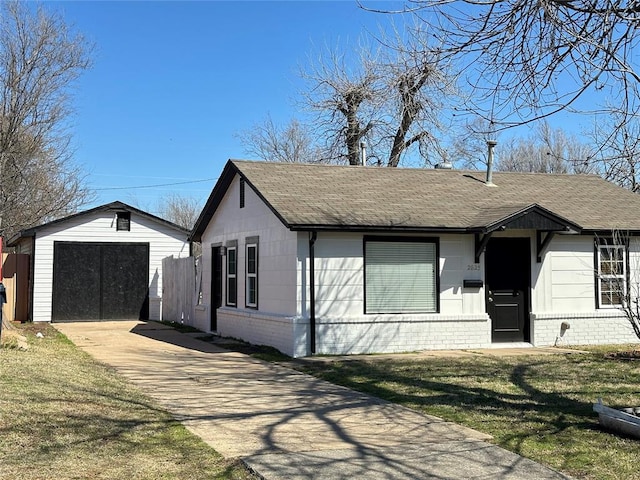 2625 SW 43rd St, Oklahoma City, OK 73119 - view of front facade featuring a shingled roof, brick siding, concrete driveway, and an outdoor structure