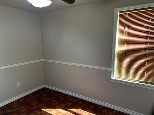 unfurnished room with baseboards