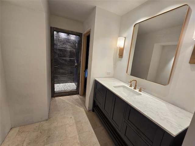 bathroom featuring stone tile flooring and vanity