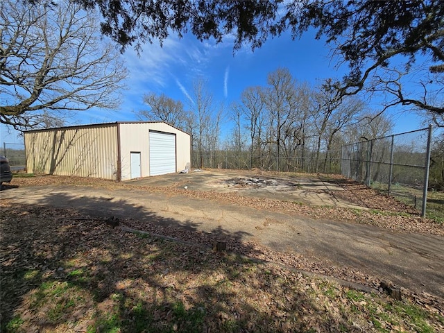 exterior space featuring driveway and fence