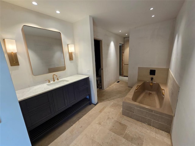 801 NE Ave C, Idabel, OK 74745 - bathroom with recessed lighting, a bath, and vanity