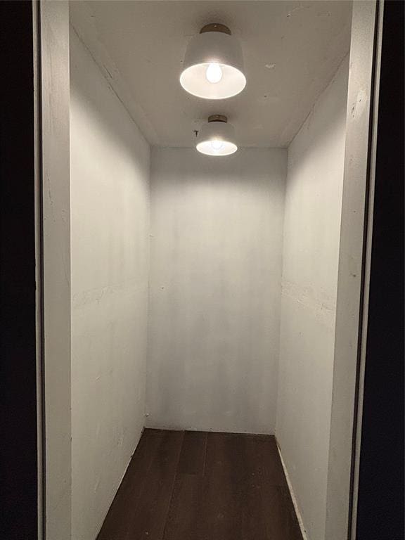 801 NE Ave C, Idabel, OK 74745 - hallway featuring dark wood-style flooring