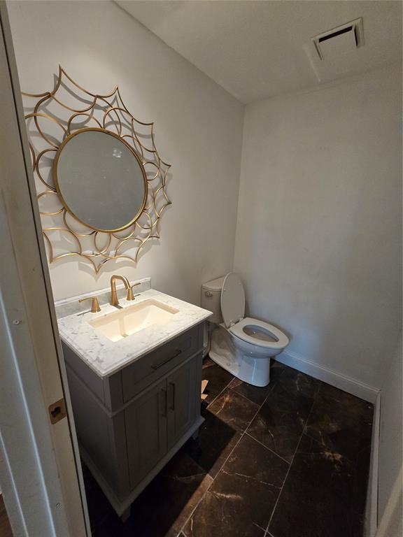 801 NE Ave C, Idabel, OK 74745 - half bath with vanity and marble look tiles