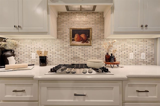 kitchen with decorative backsplash, white cabinetry, light countertops, and stainless steel gas stovetop