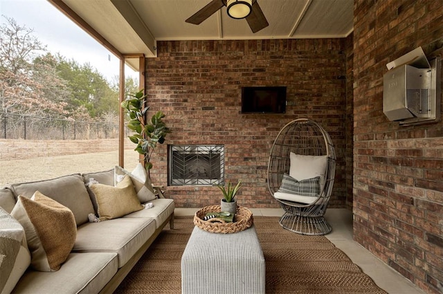 view of patio featuring an outdoor living space with a fireplace, fence, and ceiling fan