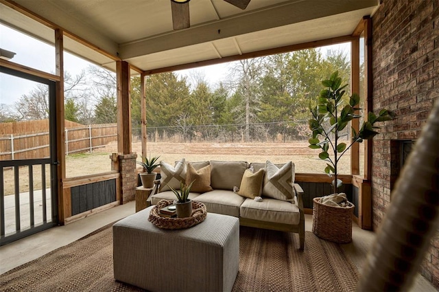 sunroom featuring an outdoor brick fireplace and ceiling fan