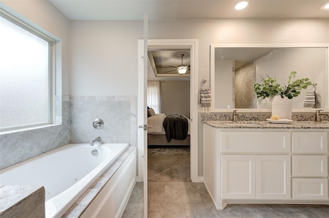 ensuite bathroom featuring ensuite bath, a garden tub, a healthy amount of sunlight, and double vanity