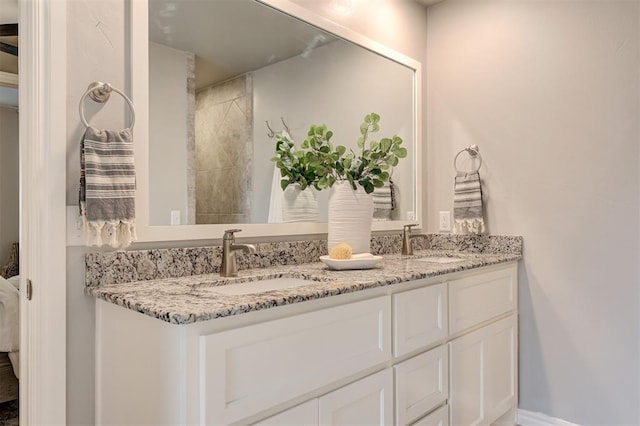 bathroom with a sink and double vanity