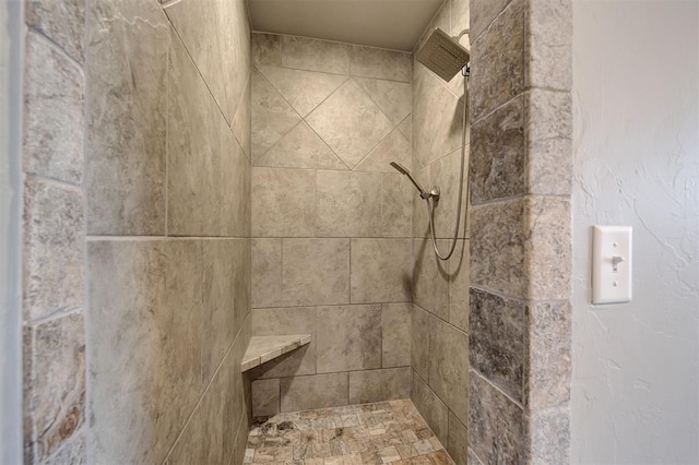 full bath featuring a tile shower