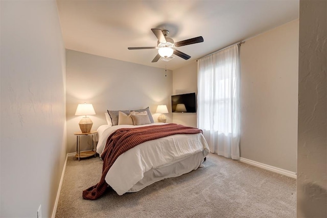 bedroom with carpet, baseboards, and ceiling fan