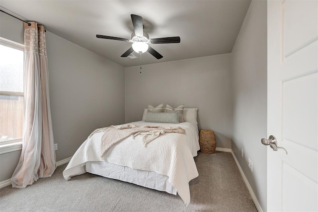 carpeted bedroom featuring a ceiling fan and baseboards