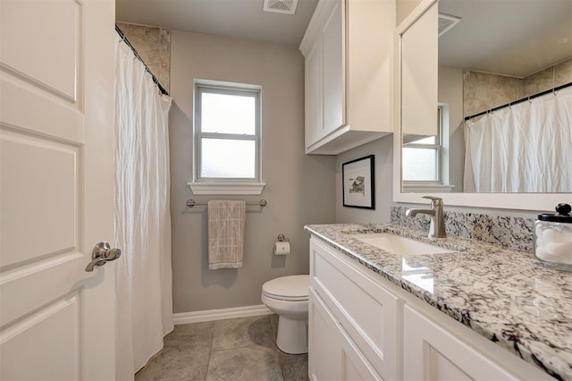 bathroom with tile patterned floors, visible vents, toilet, baseboards, and vanity