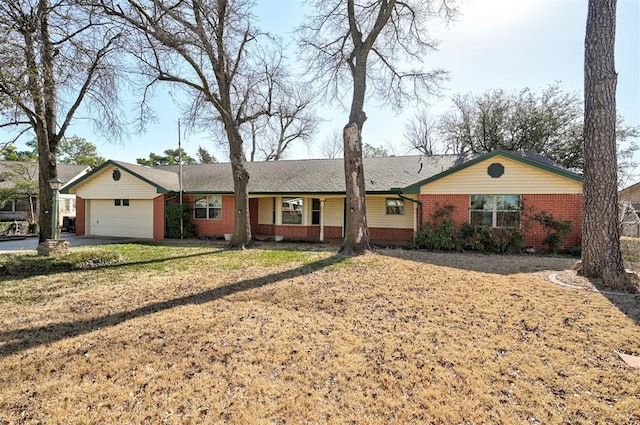 ranch-style house featuring a front yard, brick siding, and an attached garage