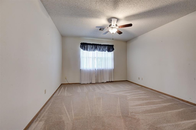 unfurnished room featuring visible vents, light carpet, a ceiling fan, a textured ceiling, and baseboards