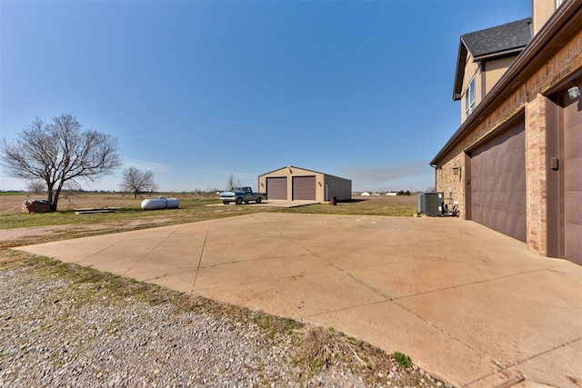 exterior space featuring an outbuilding, a garage, and central AC