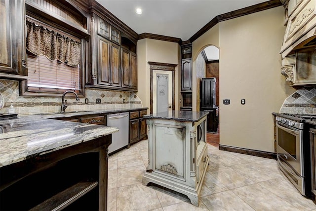 kitchen featuring dark stone countertops, stainless steel appliances, crown molding, light tile patterned floors, and dark brown cabinets